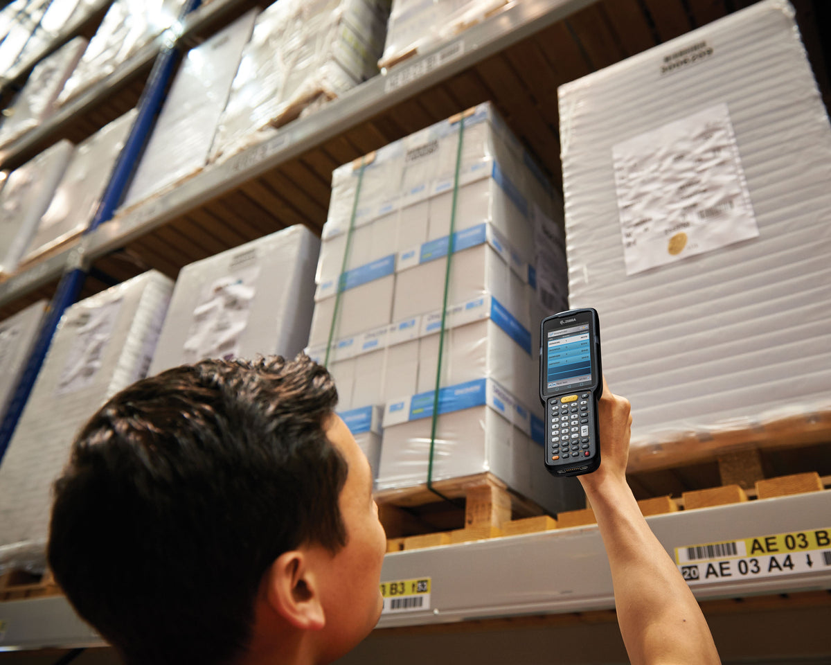 Zebra MC3300x rugged keypad mobile computer, pistol grip, 38-key function numeric keypad (MC330L-GL3EG4RW) – in use in a warehouse